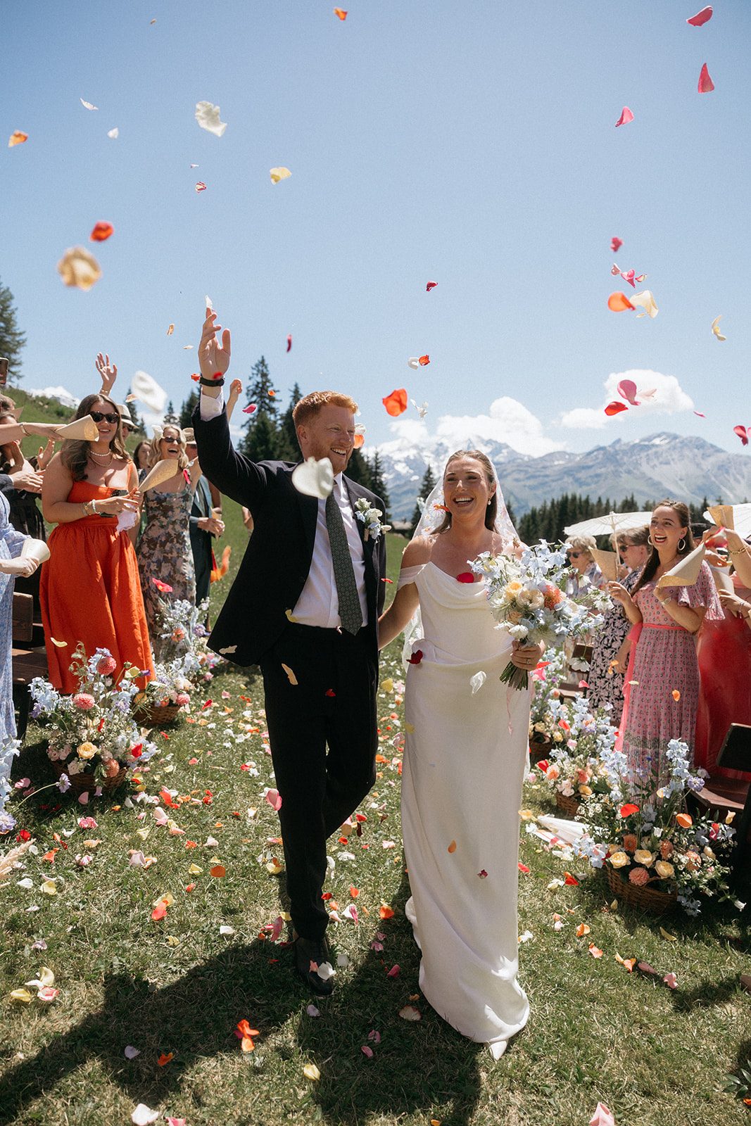Outdoor wedding ceremony at Chez Danny, Verbier, with guests laughing in the Swiss Alps